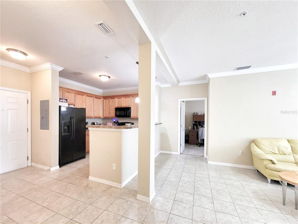 1185 Southwest 9th Road, Unit 306 Gainesville, FL 32601 - Photo 11 of 30 a view of a kitchen with refrigerator and chairs