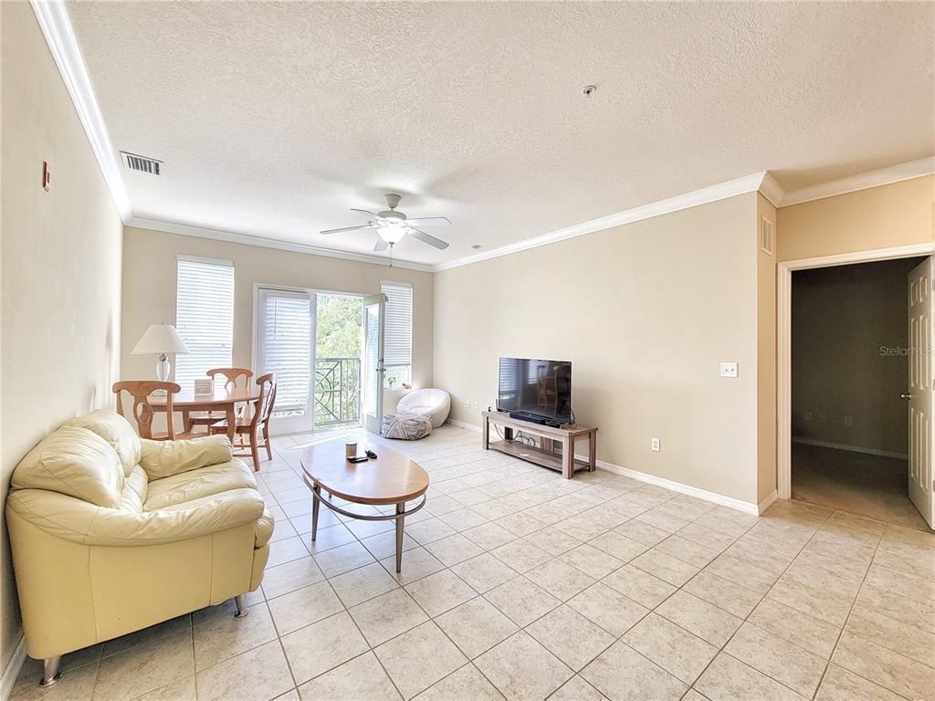 1185 Southwest 9th Road, Unit 306 Gainesville, FL 32601 - Photo 14 of 30 a living room with furniture a lamp and a window