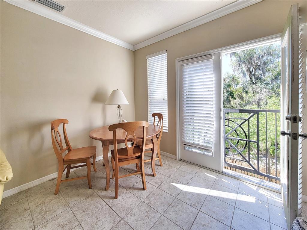1185 Southwest 9th Road, Unit 306 Gainesville, FL 32601 - Photo 15 of 30 a dining room with furniture and a floor to ceiling window