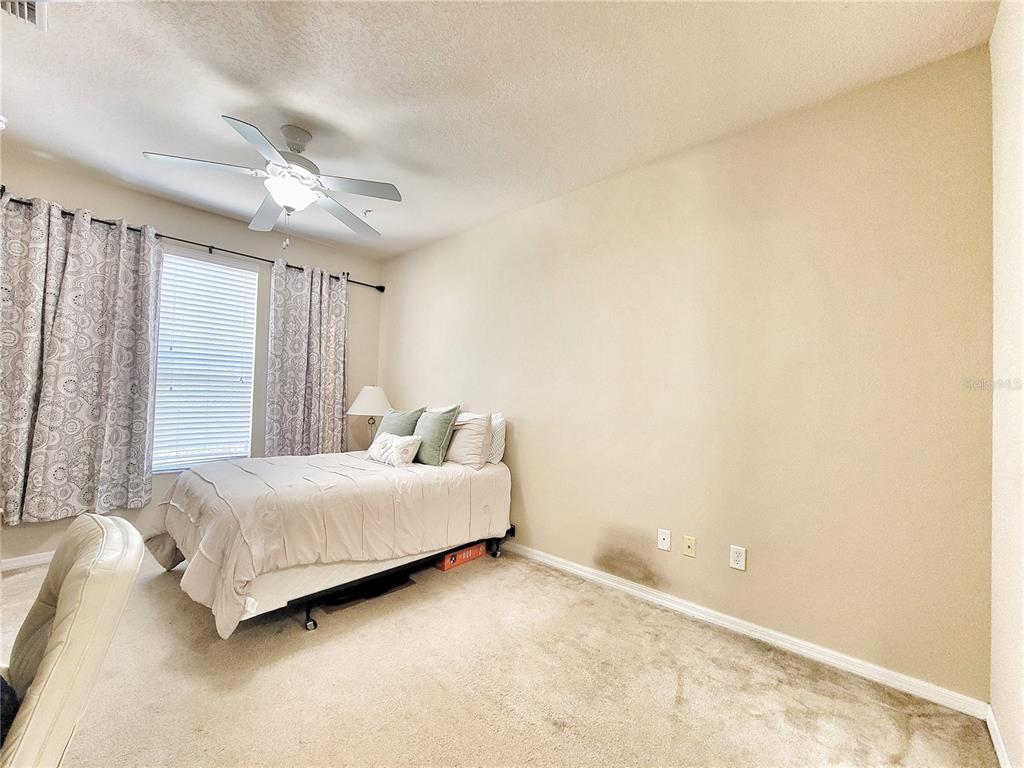 1185 Southwest 9th Road, Unit 306 Gainesville, FL 32601 - Photo 19 of 30 a bedroom with a bed and a chandelier
