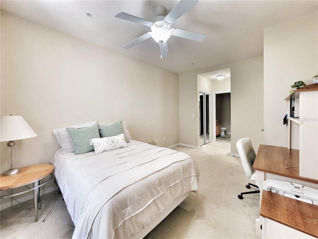 1185 Southwest 9th Road, Unit 306 Gainesville, FL 32601 - Photo 21 of 30 a bedroom with a bed and a chair