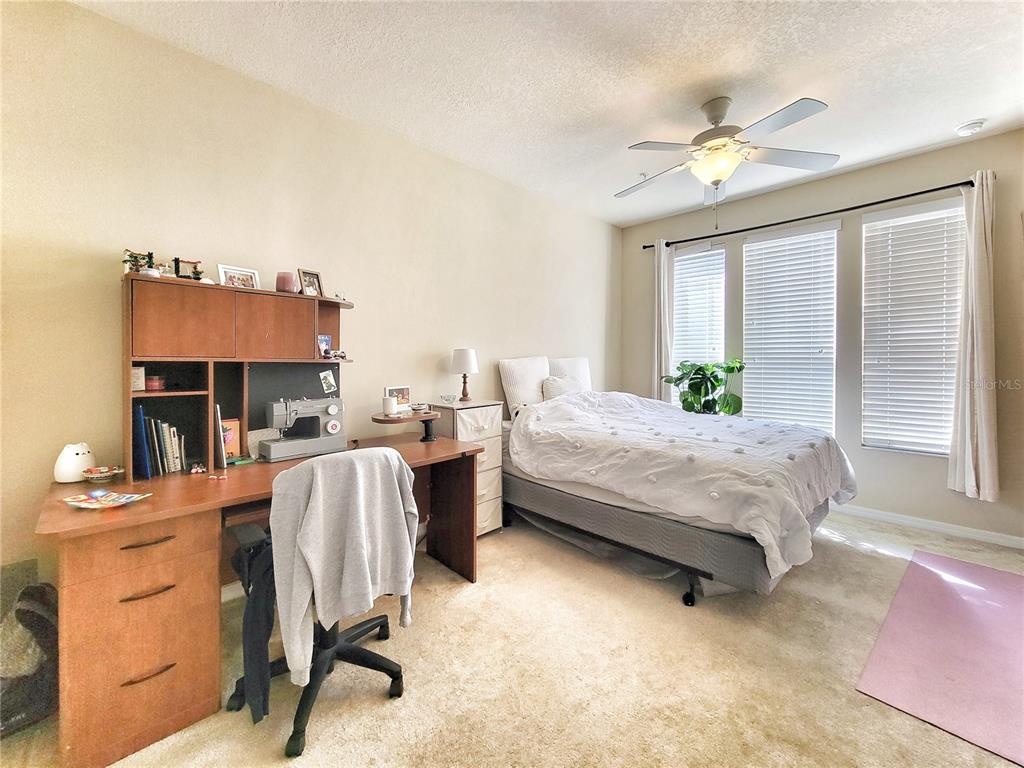 1185 Southwest 9th Road, Unit 306 Gainesville, FL 32601 - Photo 24 of 30 a bedroom with a bed furniture and windows