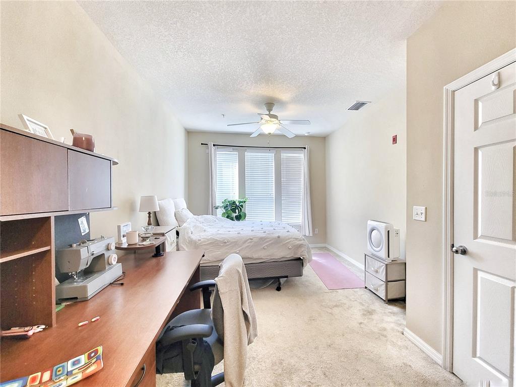 1185 Southwest 9th Road, Unit 306 Gainesville, FL 32601 - Photo 25 of 30 a living room with furniture a table and a chandelier