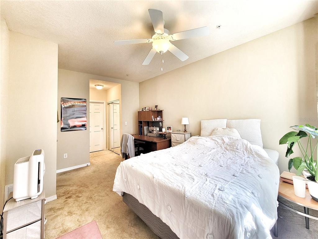 1185 Southwest 9th Road, Unit 306 Gainesville, FL 32601 - Photo 26 of 30 a bed room with a bed and a chandelier