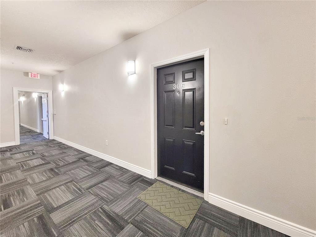 1185 Southwest 9th Road, Unit 306 Gainesville, FL 32601 - Photo 3 of 30 an empty room with wooden floor and closet