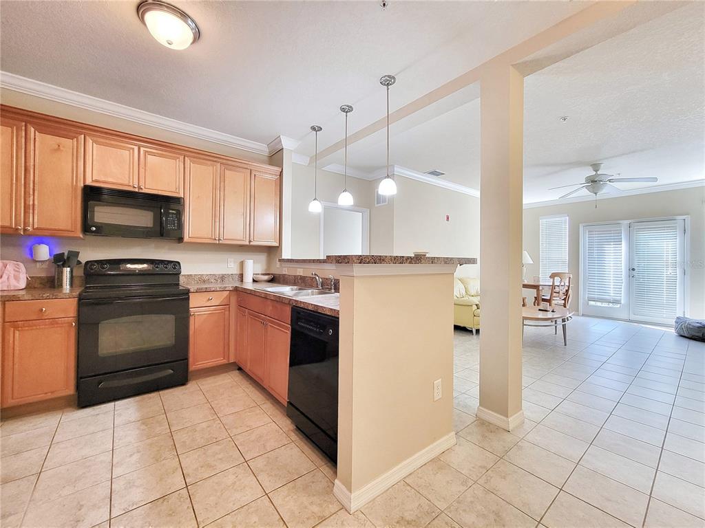 1185 Southwest 9th Road, Unit 306 Gainesville, FL 32601 - Photo 5 of 30 a kitchen with a stove a sink and a refrigerator