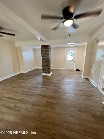 wooden floor in an empty room with a window