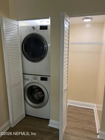 a view of a hallway with washer and dryer