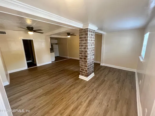 wooden floor in an empty room with a window