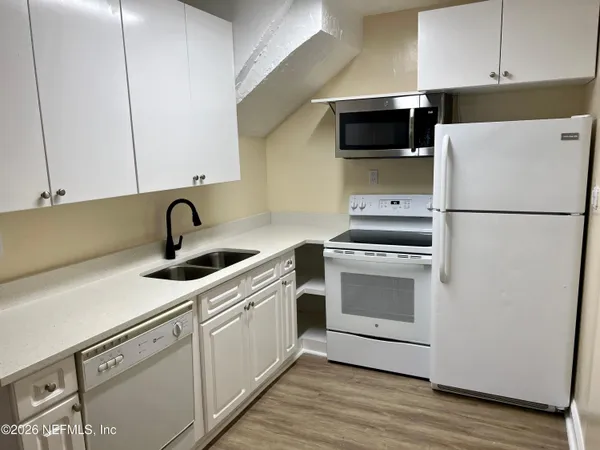 a kitchen with a sink and a stove top oven