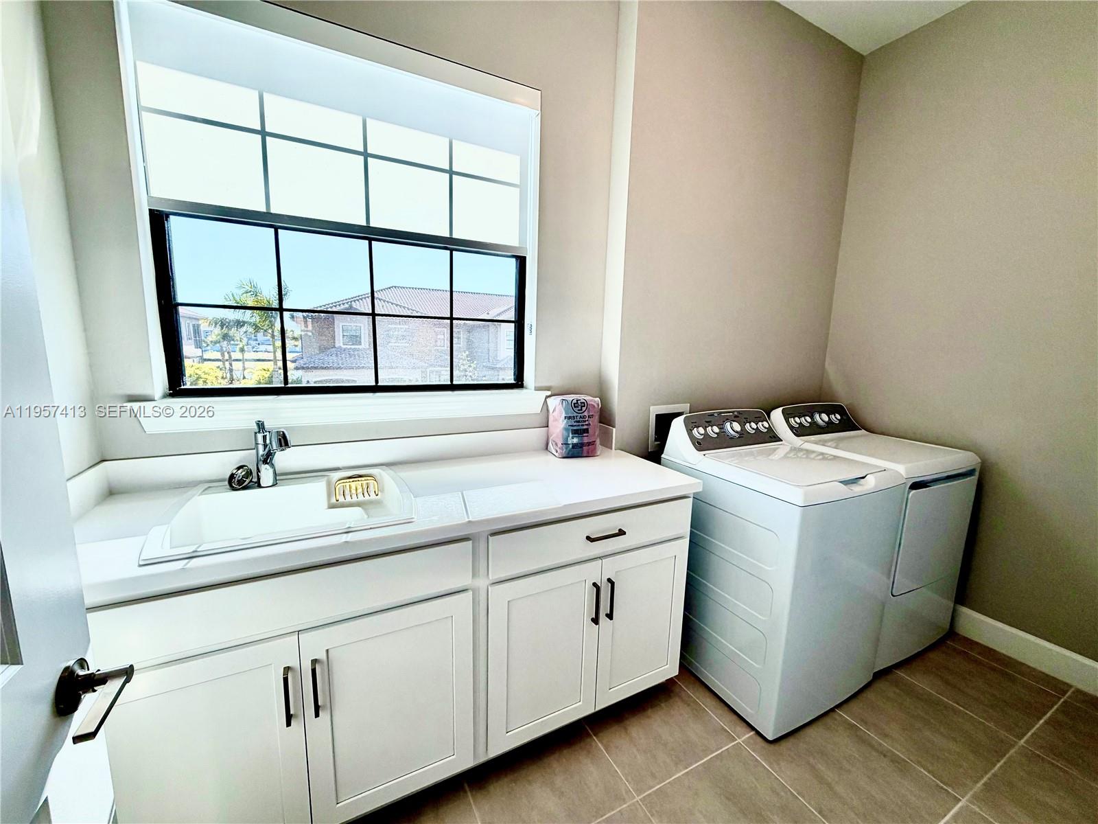 15323 Lucerna Street, Unit 204 Naples, FL 34114 - Photo 15 of 29 a utility room with dryer and washer