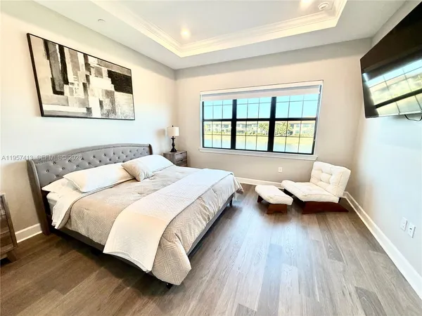 a bedroom with a bed couch and a window