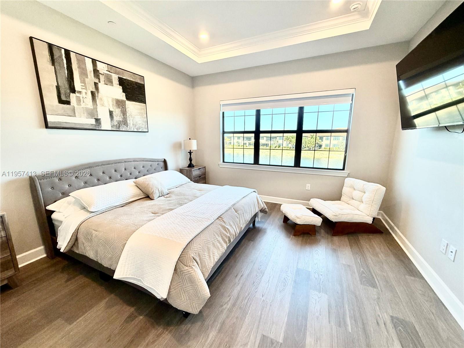 15323 Lucerna Street, Unit 204 Naples, FL 34114 - Photo 2 of 29 a bedroom with a bed couch and a window