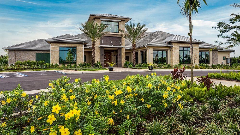 15323 Lucerna Street, Unit 204 Naples, FL 34114 - Photo 25 of 29 a front view of a house with a yard