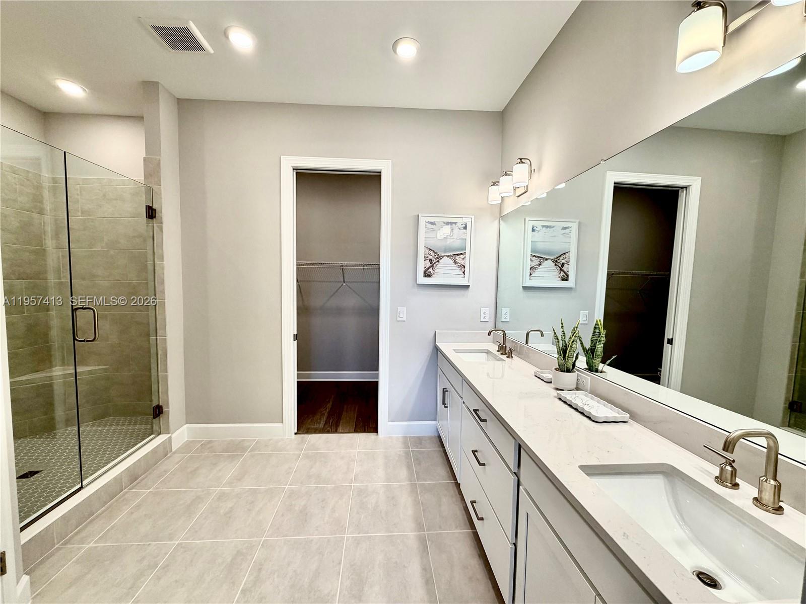 15323 Lucerna Street, Unit 204 Naples, FL 34114 - Photo 3 of 29 a spacious bathroom with a double vanity sink a large mirror a shower and a bathtub