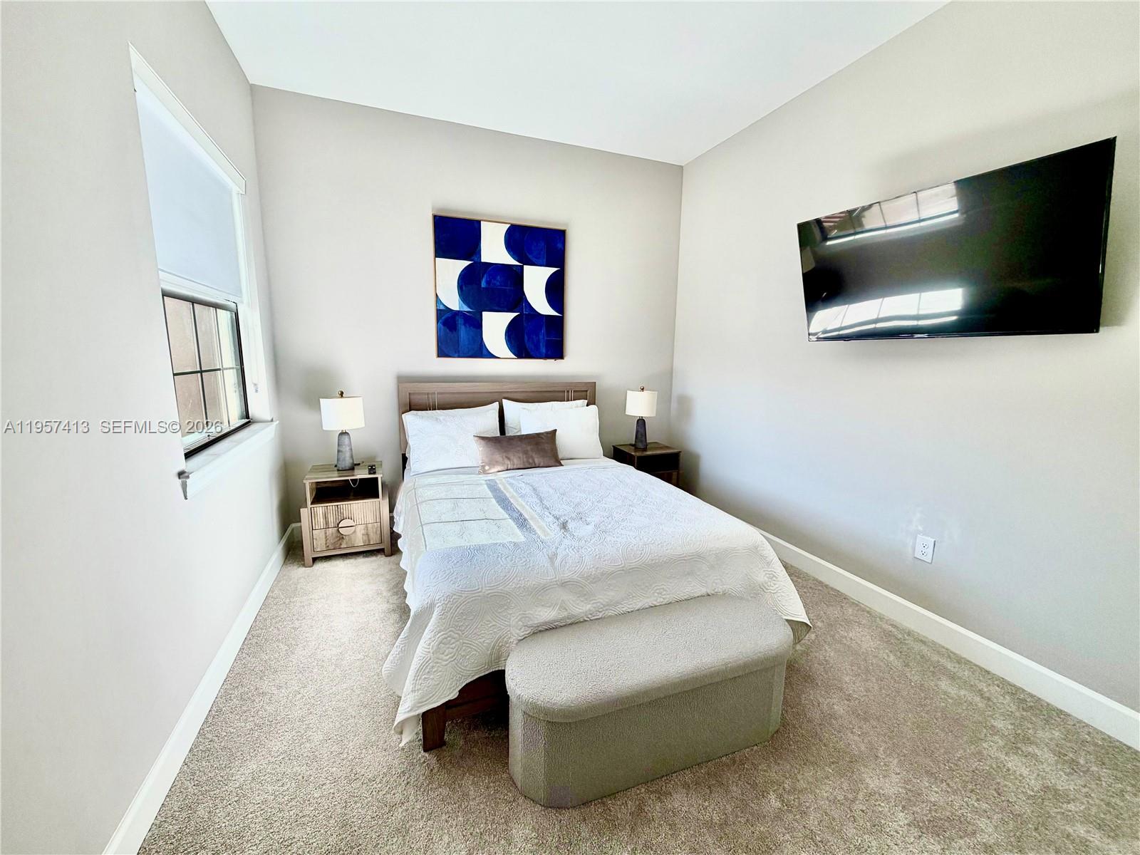 15323 Lucerna Street, Unit 204 Naples, FL 34114 - Photo 4 of 29 a bedroom with a bed and a flat screen tv