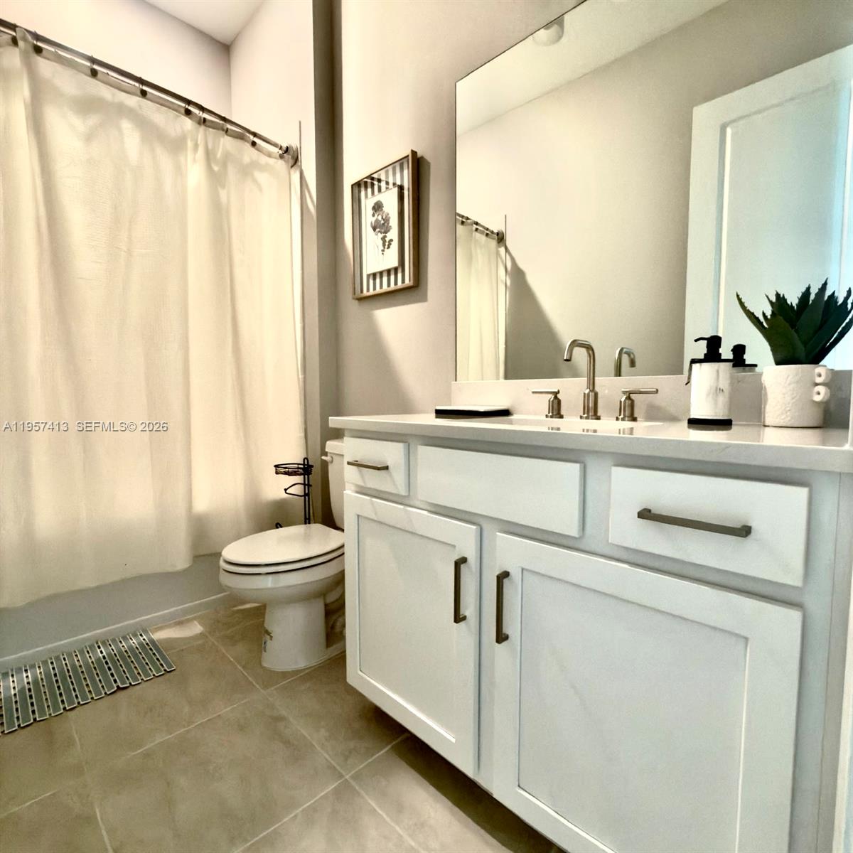 15323 Lucerna Street, Unit 204 Naples, FL 34114 - Photo 5 of 29 a bathroom with a sink a toilet and a mirror