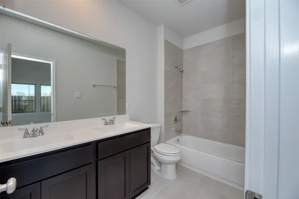 a bathroom with a sink toilet tub and shower