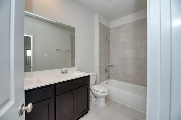 a bathroom with a sink toilet vanity and shower