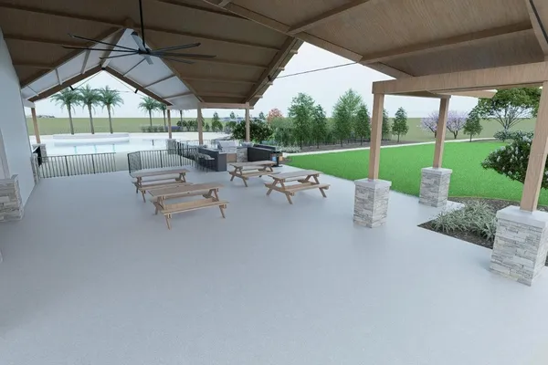 a view of a patio with a table chairs and a small yard
