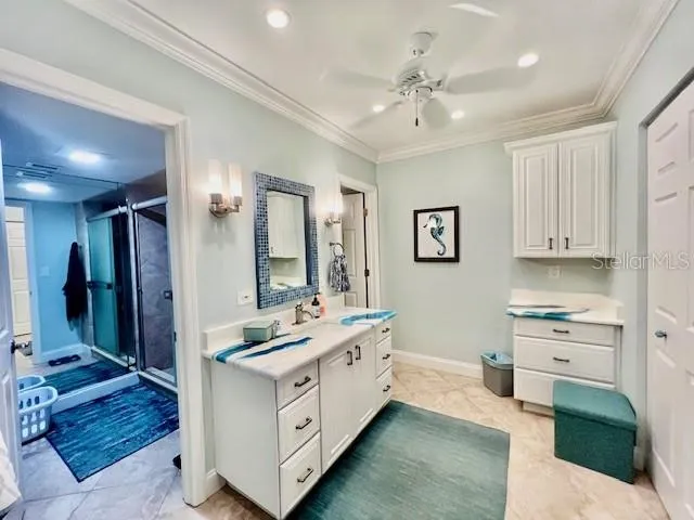 a spacious bathroom with a double vanity sink a mirror and a shower