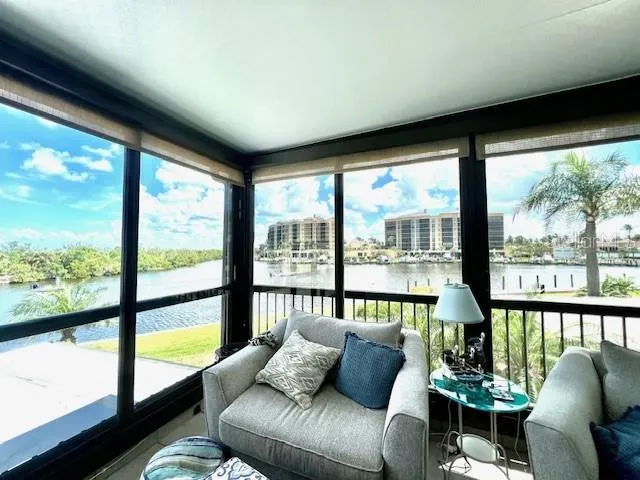 a living room with furniture and floor to ceiling windows