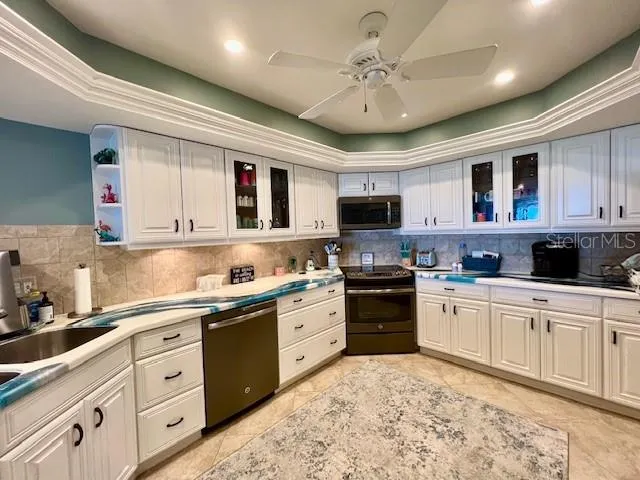 a kitchen with stainless steel appliances granite countertop a sink and cabinets