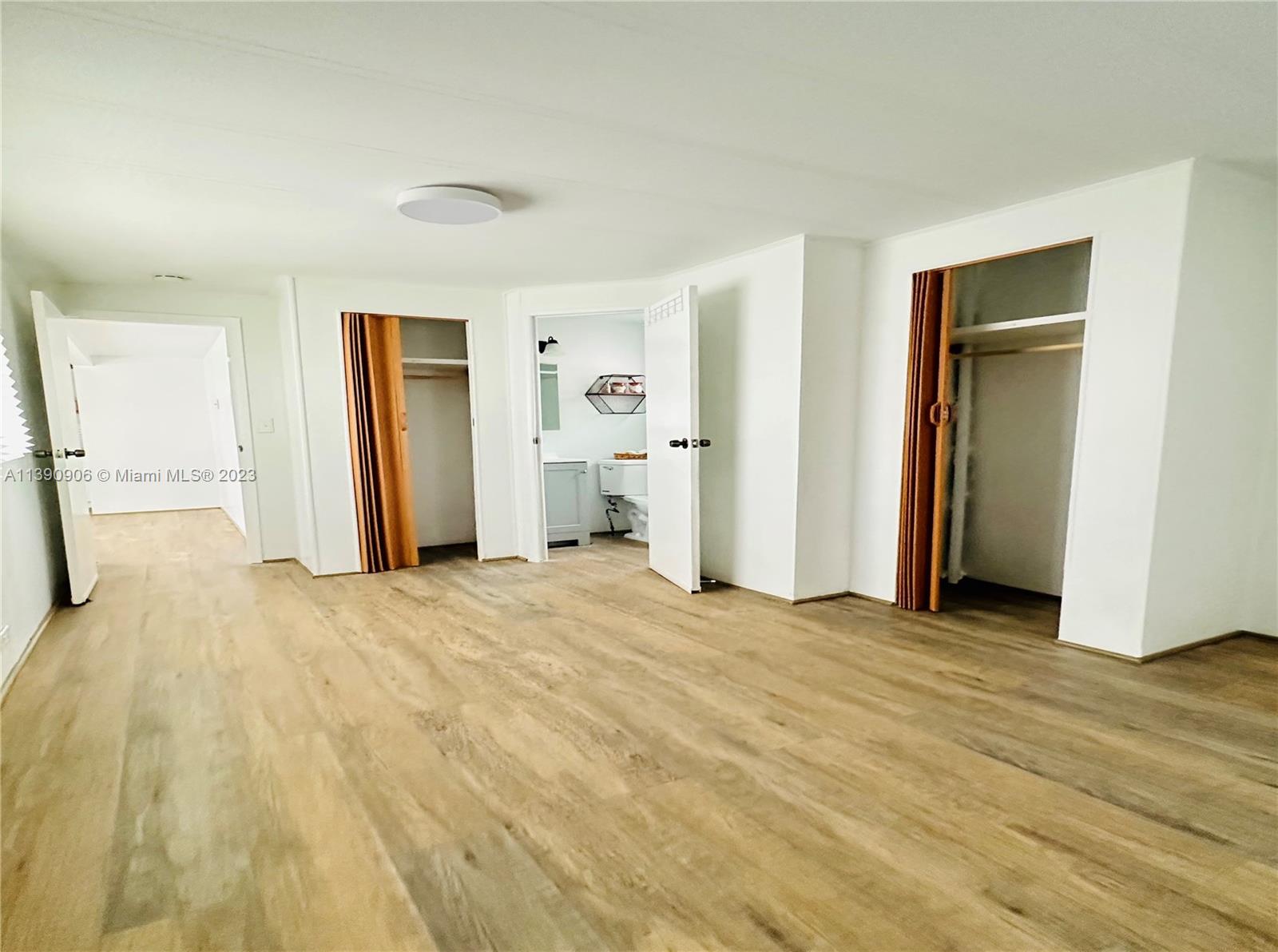 451 Southeast 8th Street Homestead, FL 33030 - Photo 5 of 10 a view of empty room with wooden floor