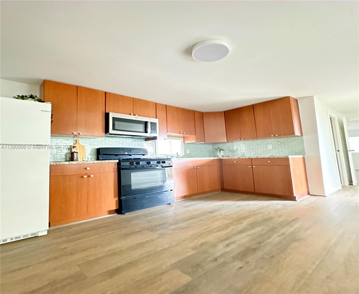 451 Southeast 8th Street Homestead, FL 33030 - Photo 7 of 10 a kitchen with stainless steel appliances granite countertop a refrigerator sink and stove