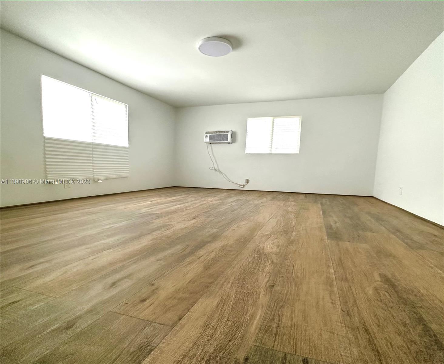 451 Southeast 8th Street Homestead, FL 33030 - Photo 8 of 10 an empty room with wooden floor and windows