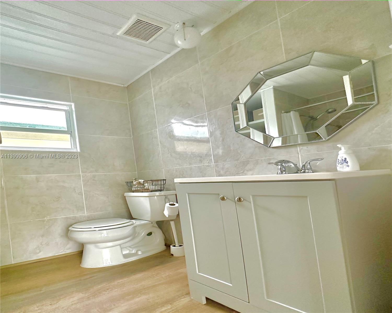 451 Southeast 8th Street Homestead, FL 33030 - Photo 9 of 10 a bathroom with a toilet sink and mirror