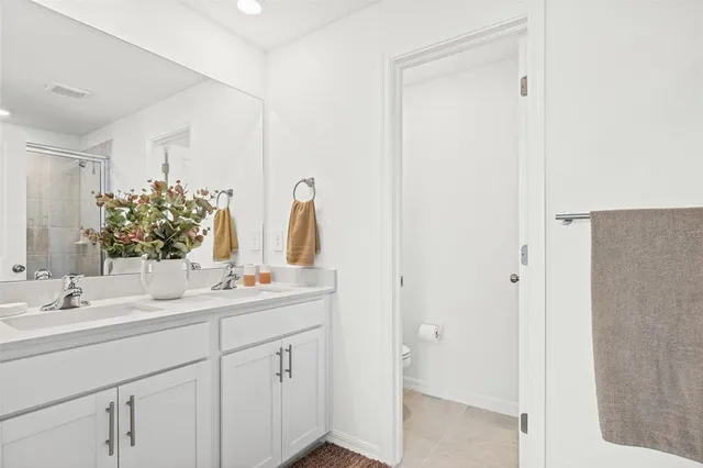 a bathroom with a double vanity sink and a mirror