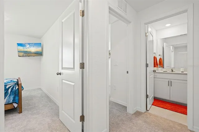 a view of hallway with sink and mirror