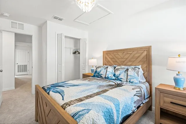 a bedroom with a bed and a lamp