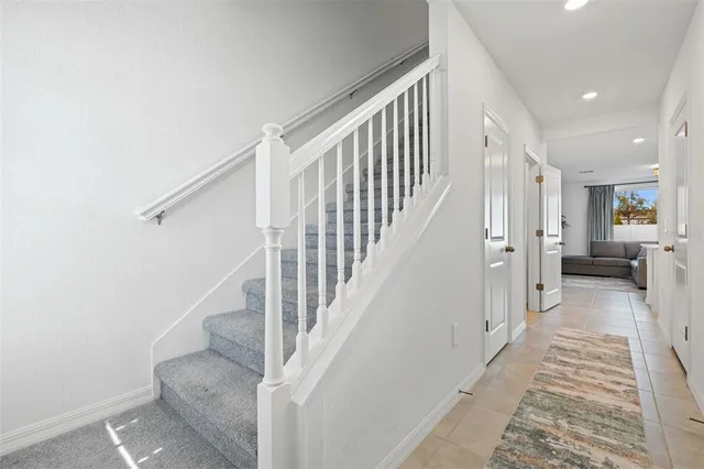 a view of a hallway with wooden floor and entryway