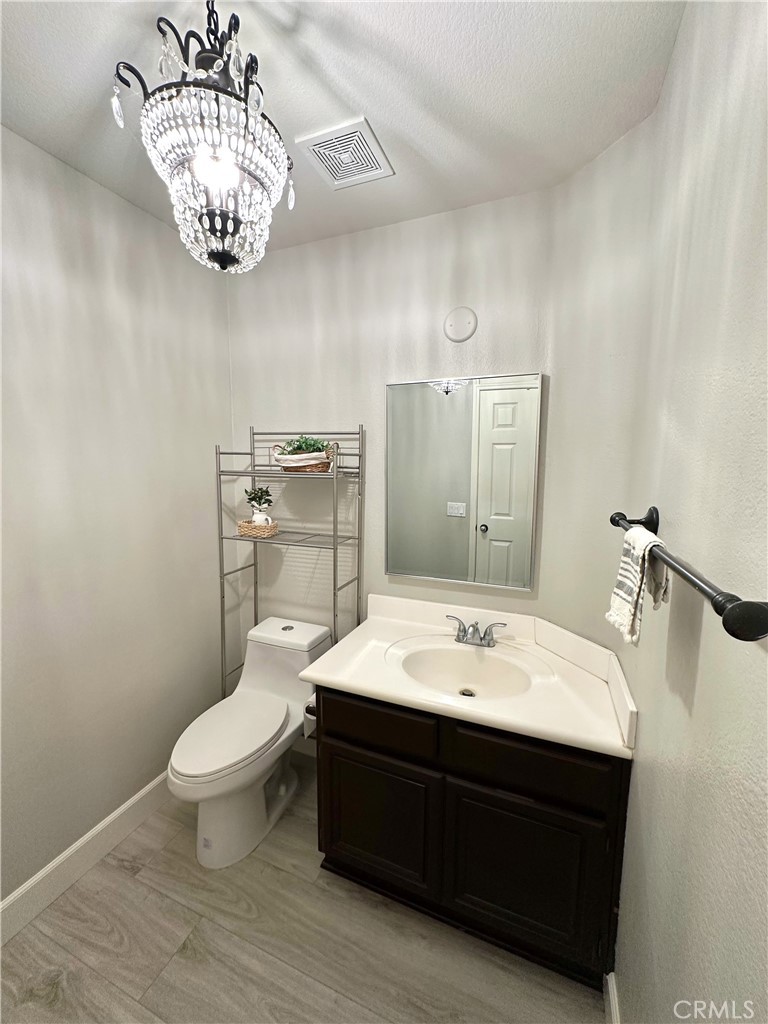 33878 Channel Street Temecula, CA 92592 - Photo 11 of 14 a bathroom with a sink a toilet and mirror