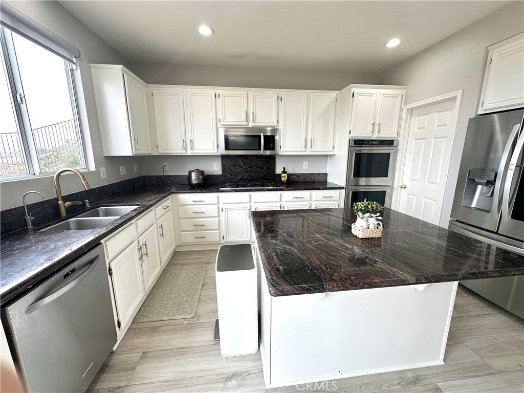 33878 Channel Street Temecula, CA 92592 - Photo 3 of 14 a large kitchen with stainless steel appliances granite countertop a stove a sink a microwave and a refrigerator
