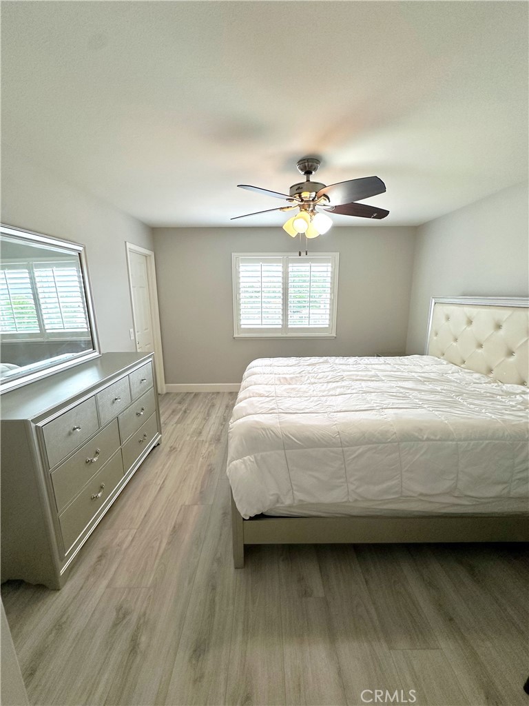 33878 Channel Street Temecula, CA 92592 - Photo 10 of 14 a bedroom with a bed and a chandelier