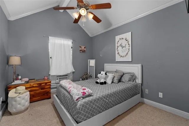 a bedroom with bed and a chandelier