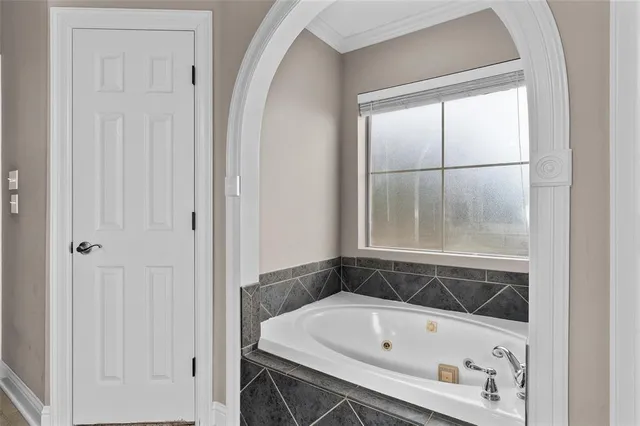 a bathroom with a tub and shower