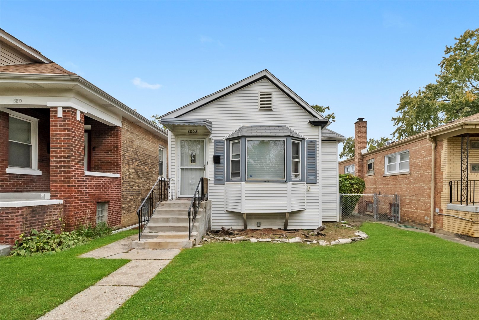8808 South Loomis Street Chicago, IL 60620 - Photo 1 of 32 a front view of a house with a yard