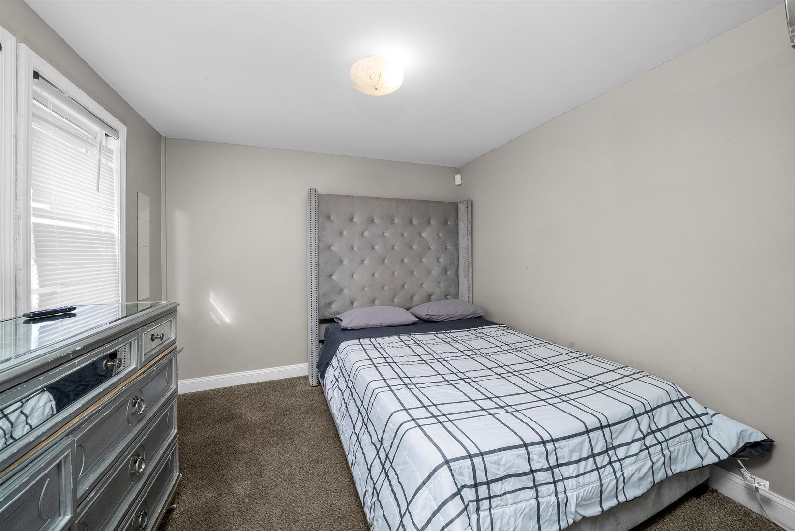 8808 South Loomis Street Chicago, IL 60620 - Photo 17 of 32 a bedroom with a bed and a window