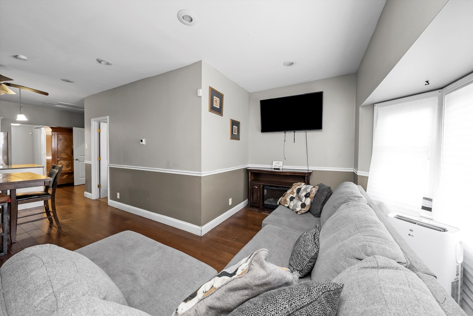 8808 South Loomis Street Chicago, IL 60620 - Photo 3 of 32 a living room with furniture and a flat screen tv