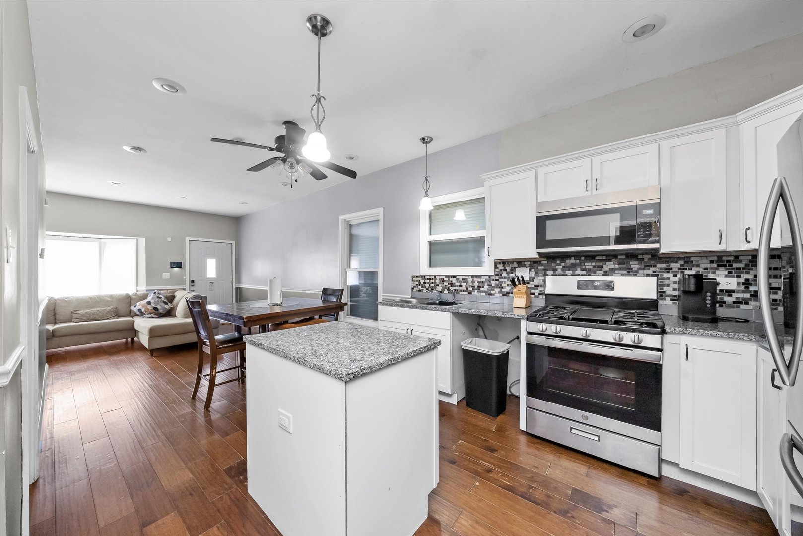 8808 South Loomis Street Chicago, IL 60620 - Photo 5 of 32 a kitchen with stove cabinets and wooden floor