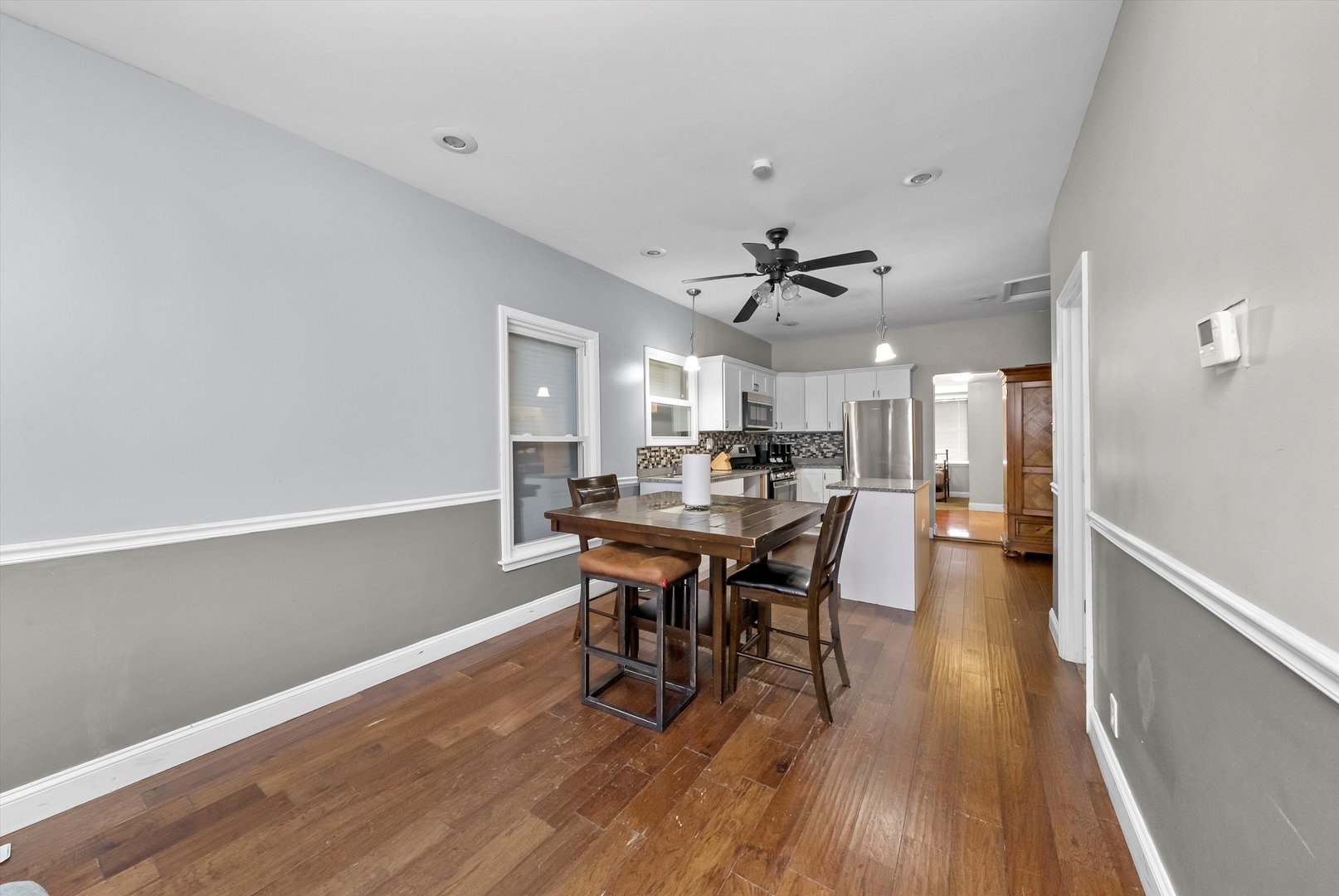 8808 South Loomis Street Chicago, IL 60620 - Photo 10 of 32 a view of a dining room with furniture and wooden floor