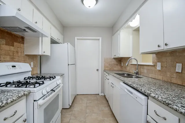 a kitchen with a sink stove and cabinets