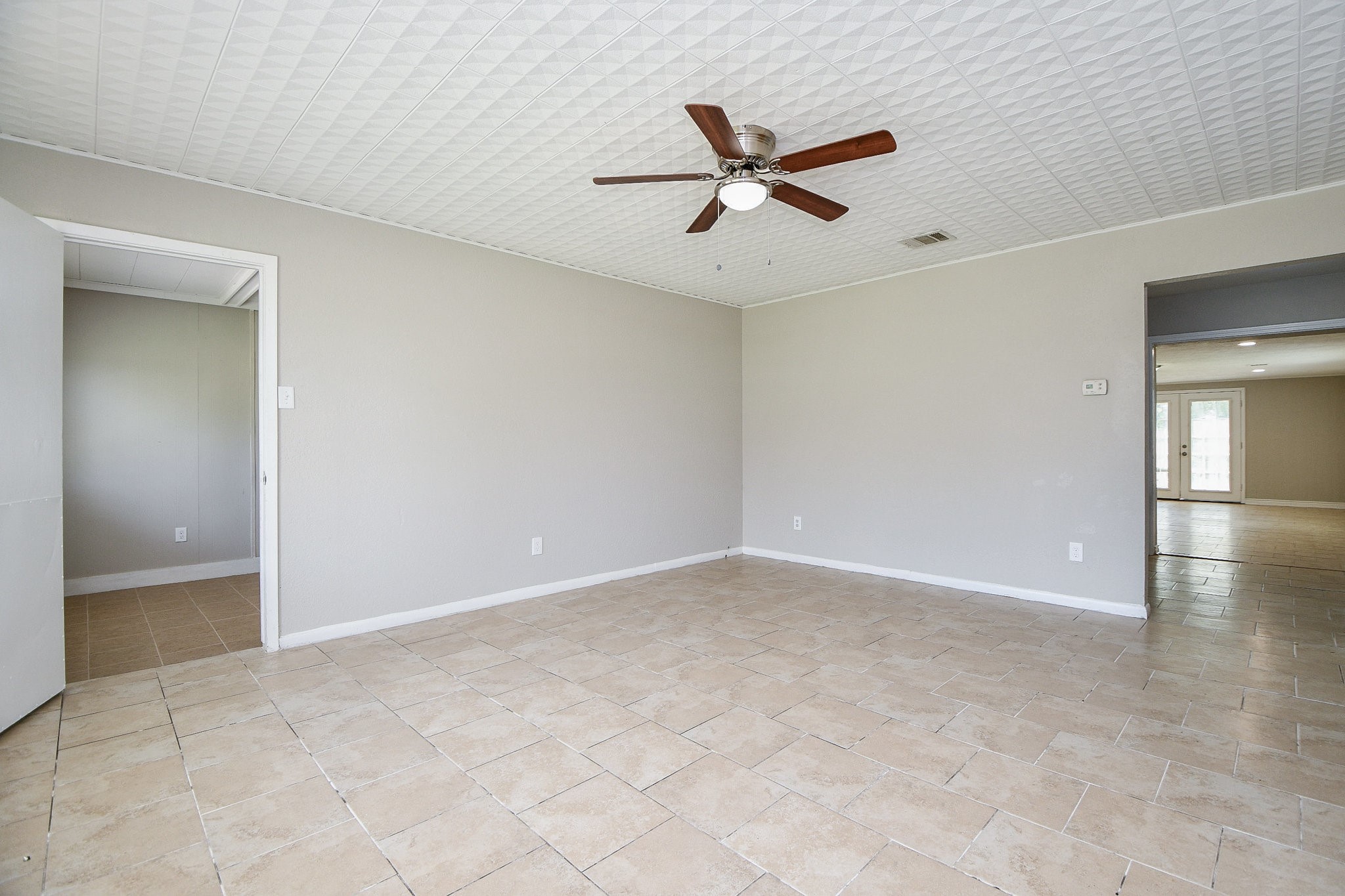 14902 Gloster Street Channelview, TX 77530 - Photo 7 of 21 an empty room with a ceiling fan and carpet