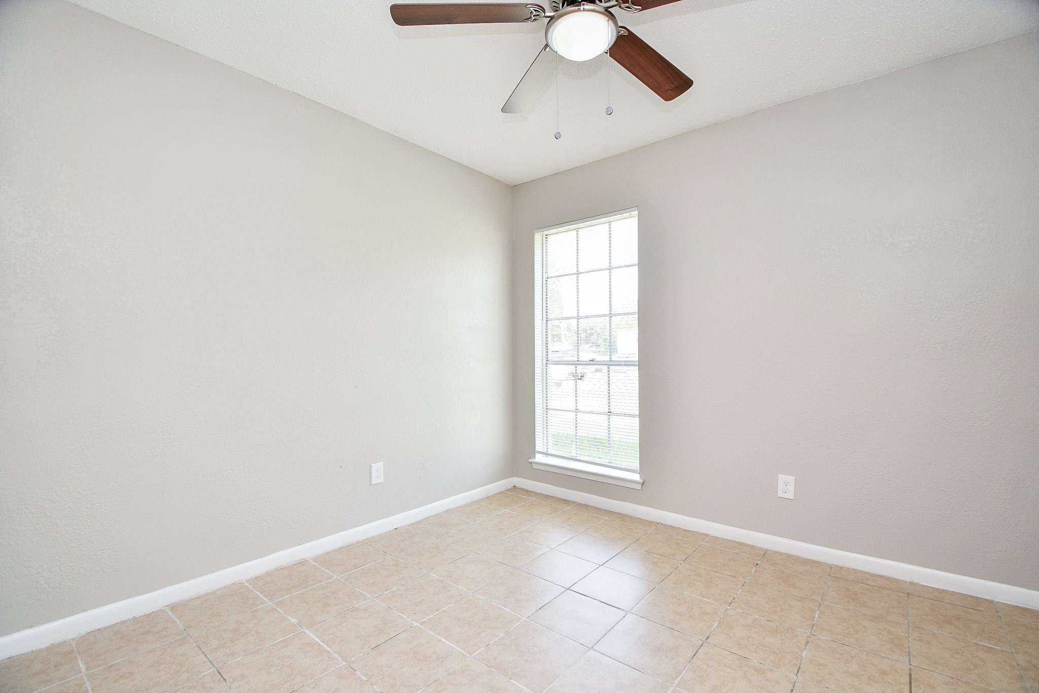 14902 Gloster Street Channelview, TX 77530 - Photo 10 of 21 an empty room with windows and fan