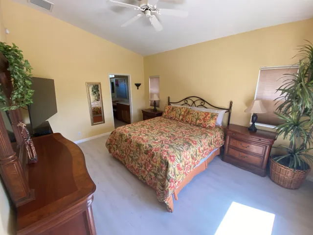 a bedroom with a bed window and couch