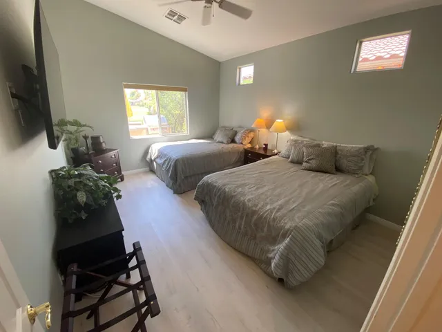 a bedroom with two beds and a window